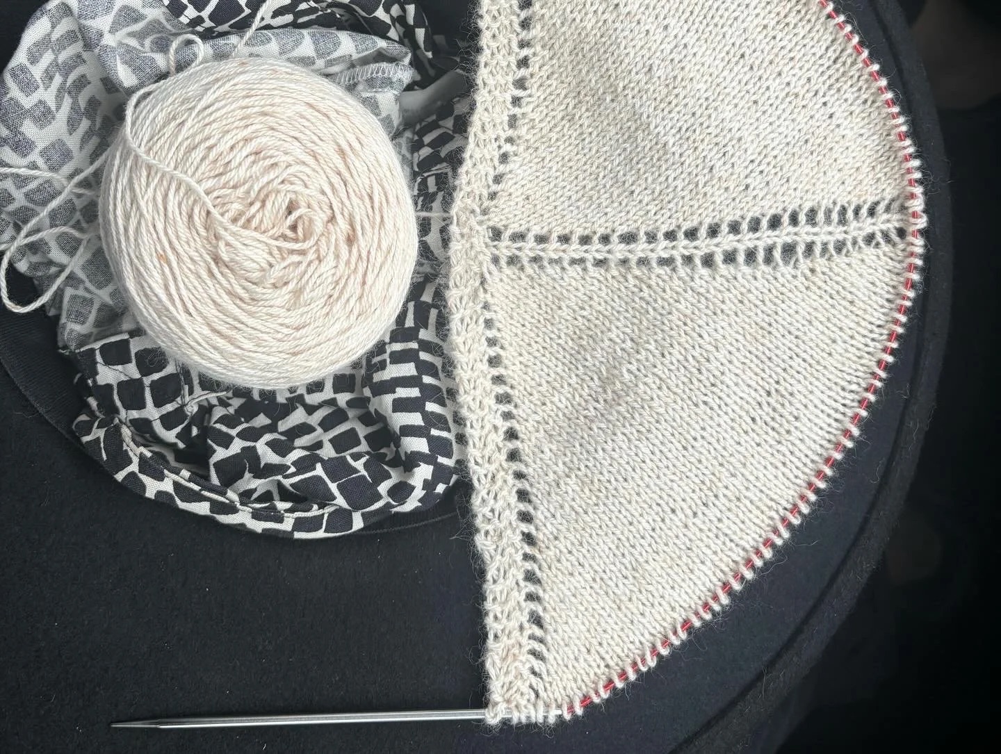 Knitting in progress with cream yarn